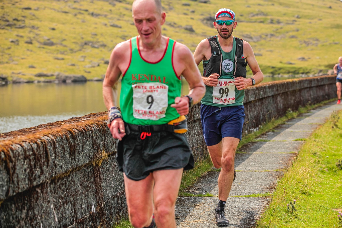 Running along the dam at Seathwaite Tarn