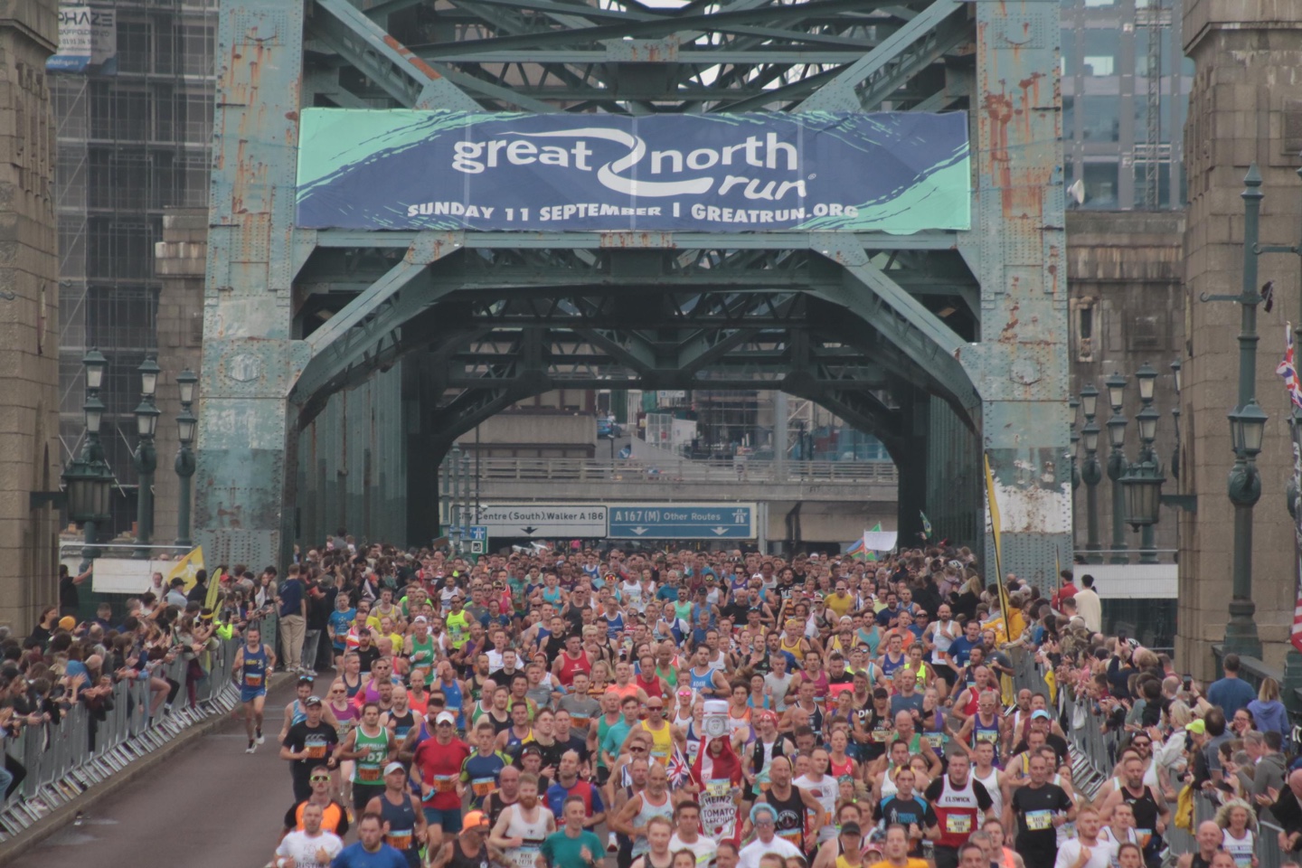 Thousands of runners cross the Tyne Bridge. The author is visible to the right, blended into the throng.