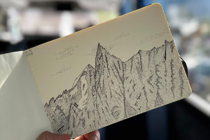 A pen drawn sketch of a mountain, using dots for shading.