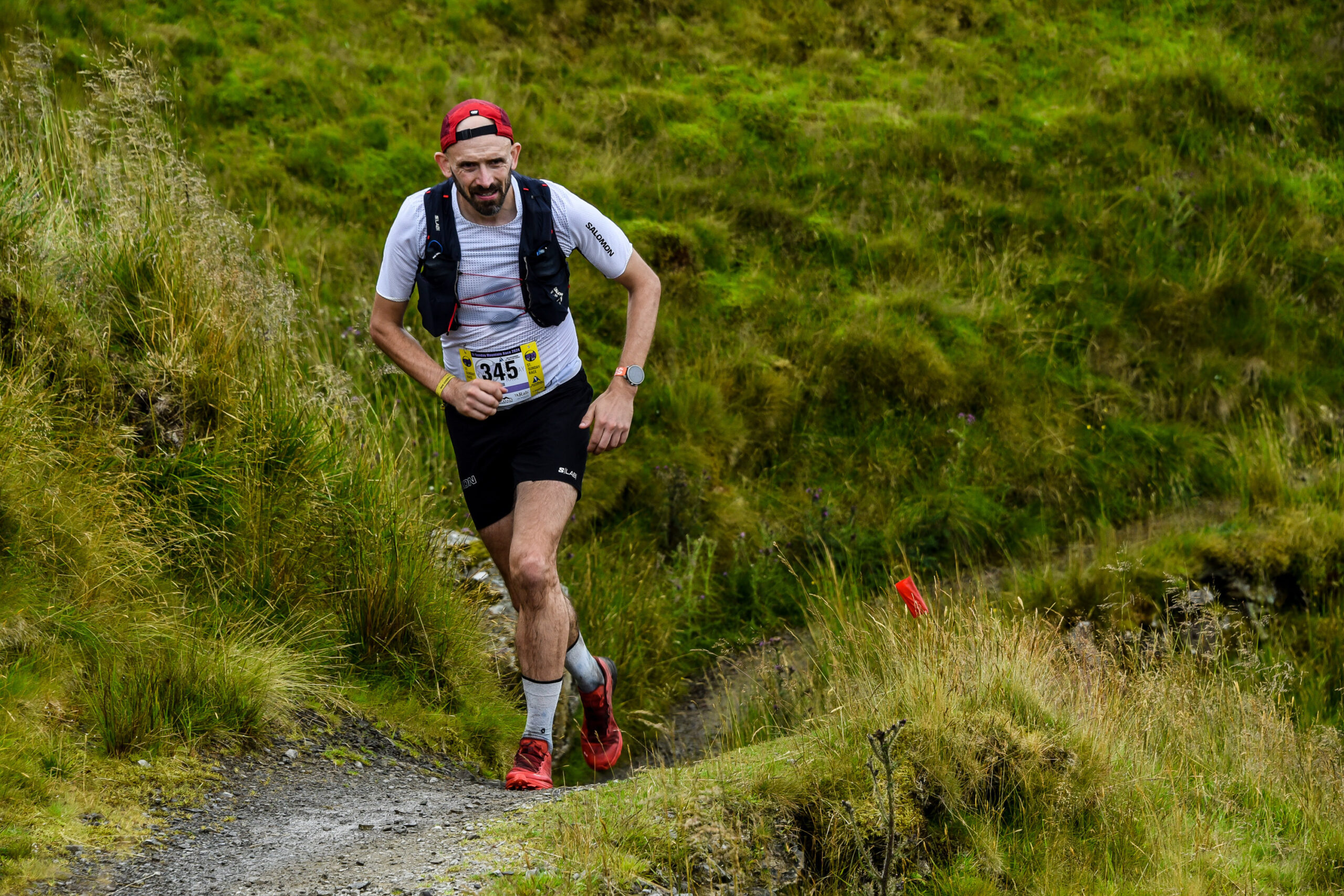 A trail runner runs along a path