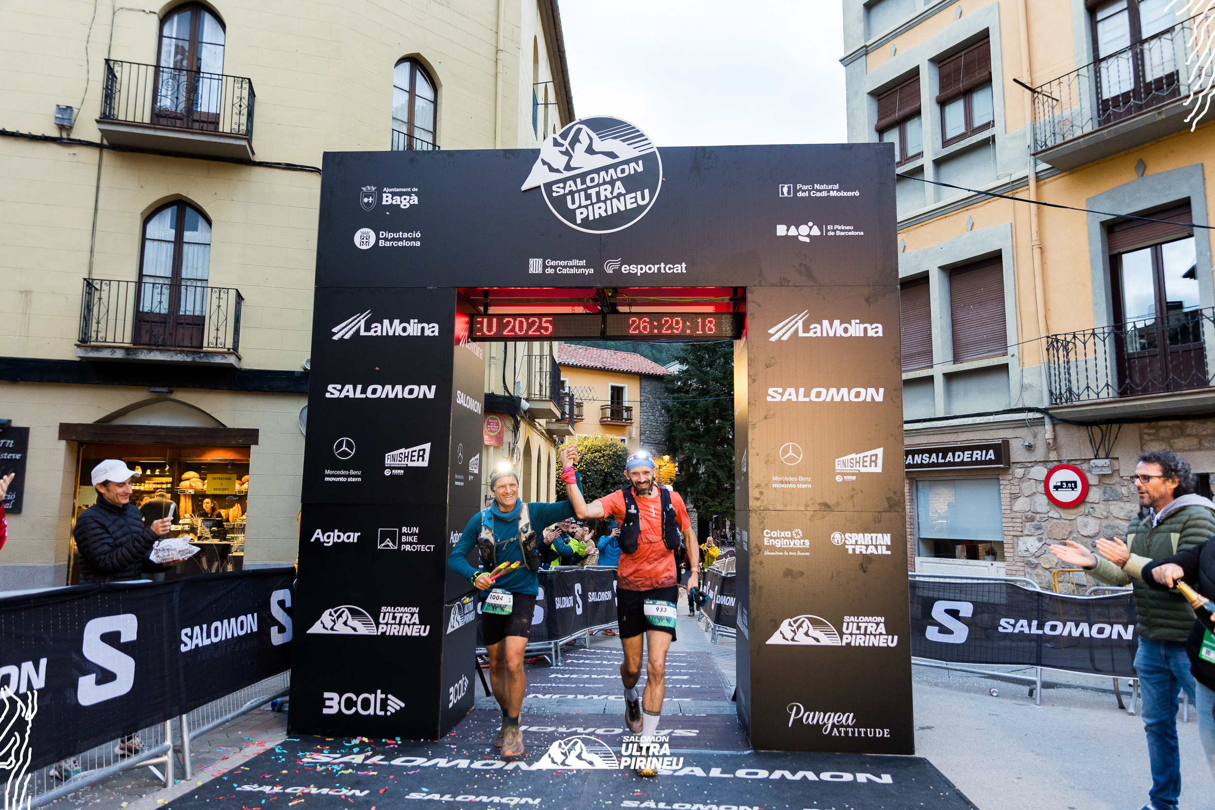 Two men cross the finish line of the Salomon Ultra Pirineu race